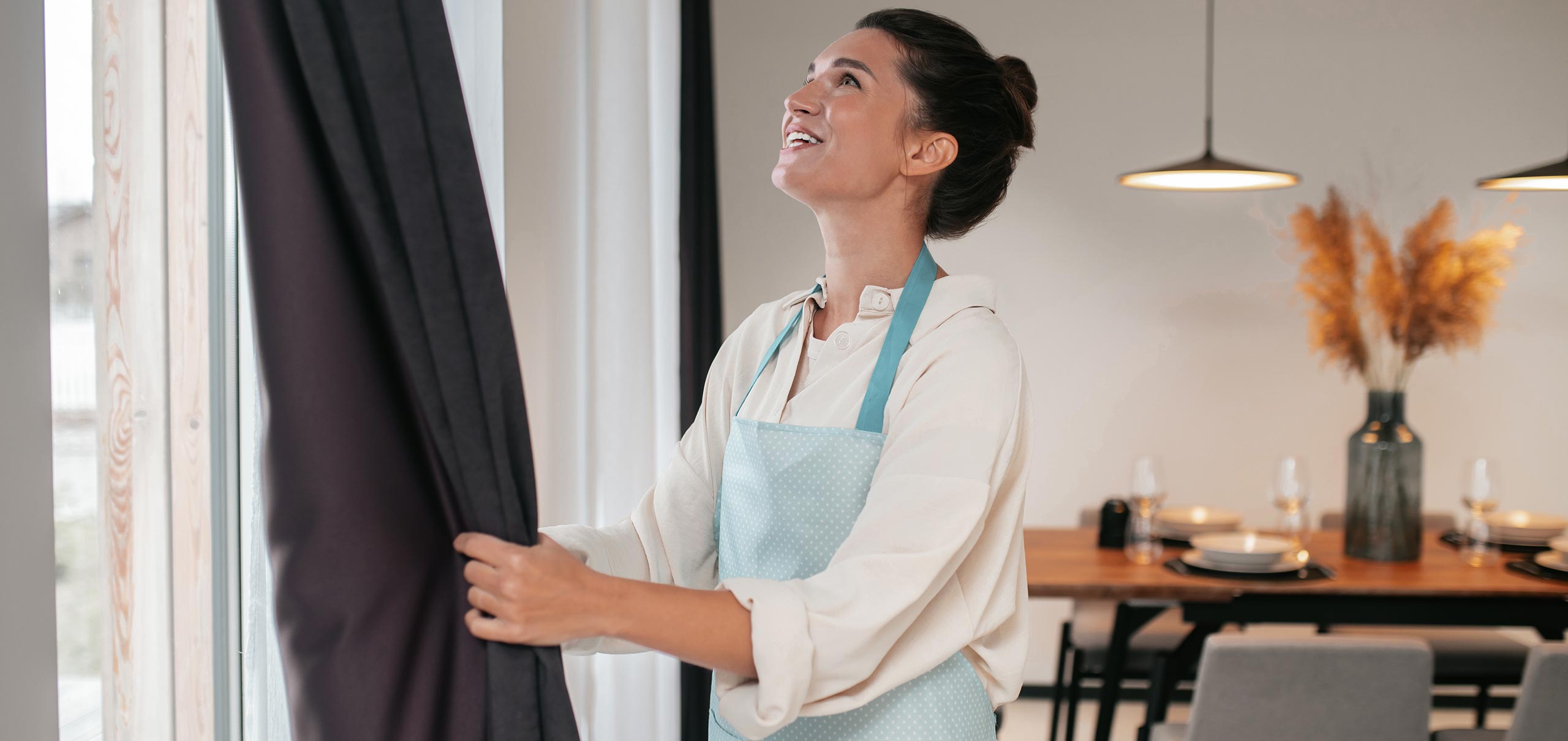 https://dindicdoo.com/wp-content/uploads/2022/03/young-woman-standing-near-widnow-fixing-curtains.jpg